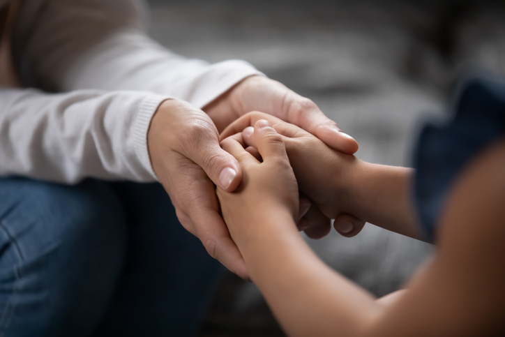 woman and child holding hands