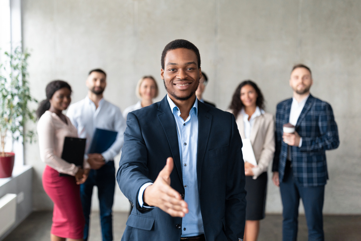 Team member extending handshake