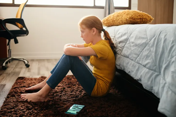 Young woman sitting on floor
