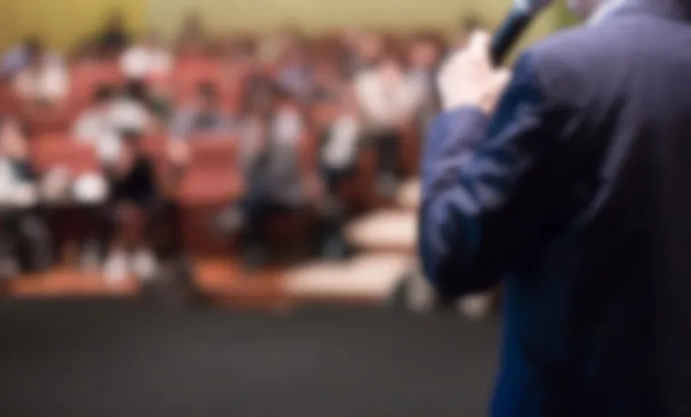 Blurred shot of speaker and audience